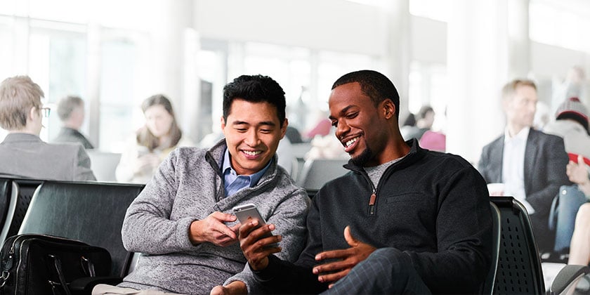 Two men looking at phone