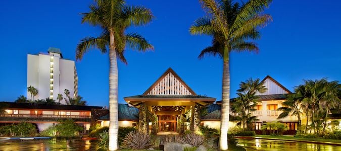 palm trees in front of hotel